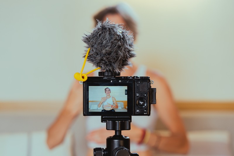 Photo of a Video Camera Recording a Woman