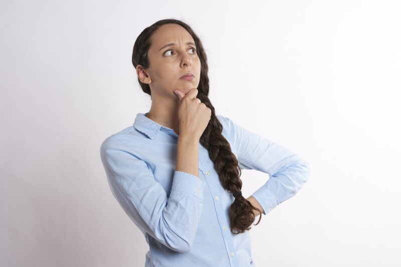 Woman with her hands on her chin thinking