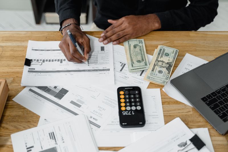 a person counting money and doing report