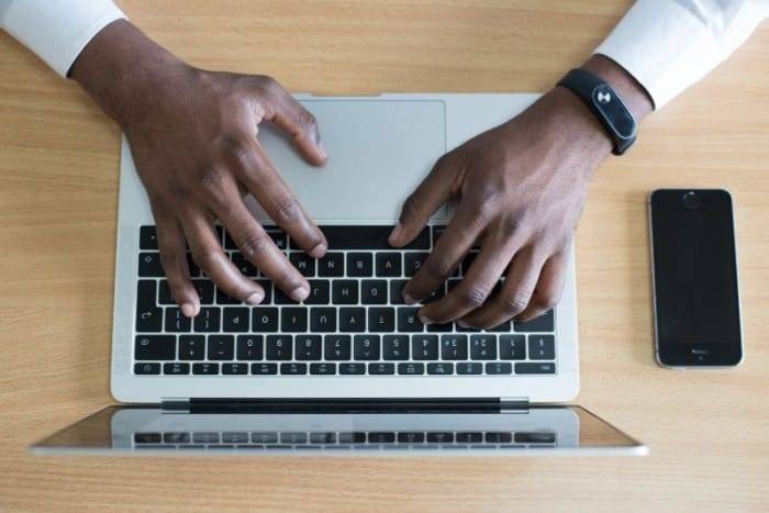 Man Typing on a Laptop