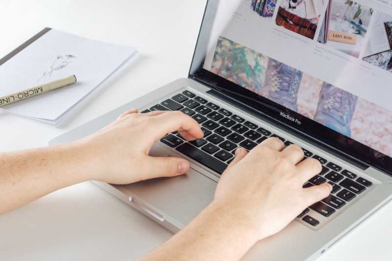 hands typing on a computer