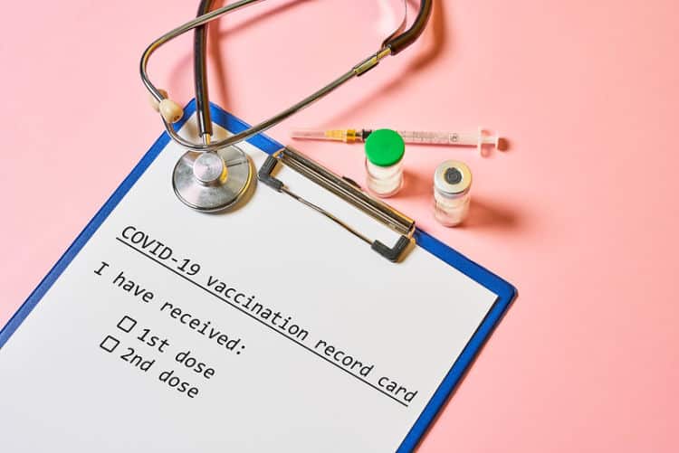 Stethoscope and a file on a pink background