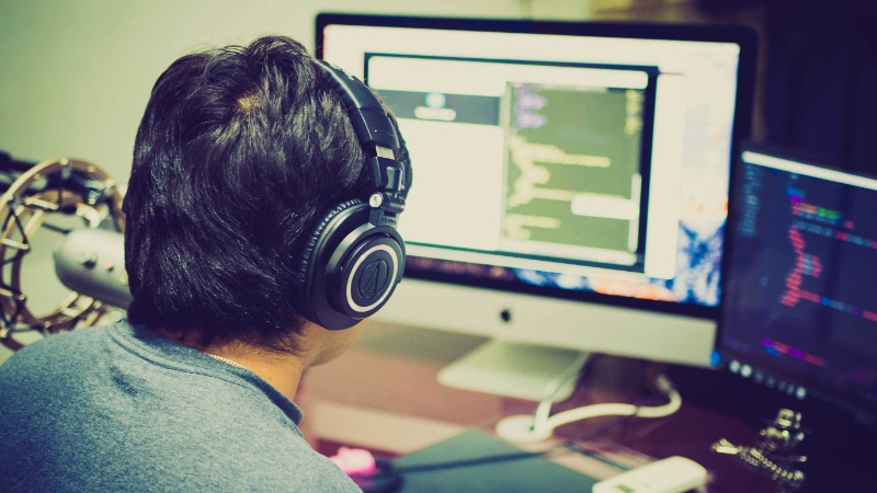 Man in front of two monitors