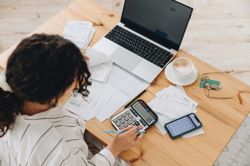 Woman using a calculator while working