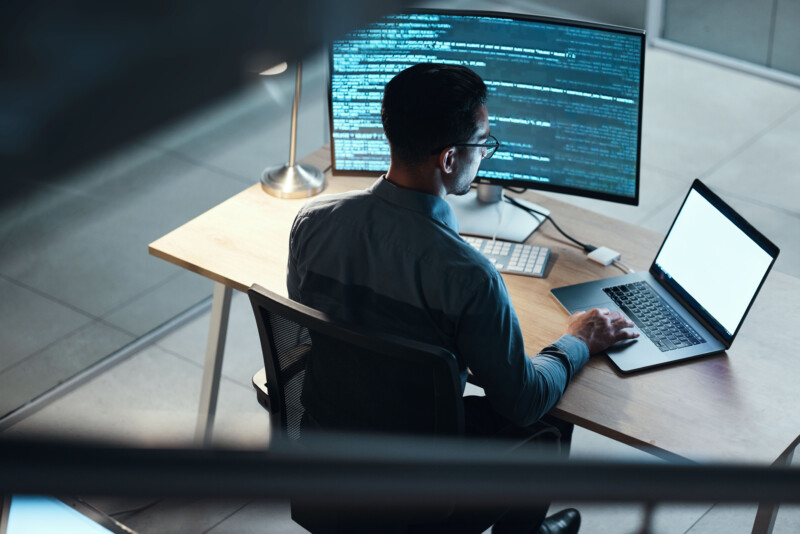 Man programming and coding on a laptop