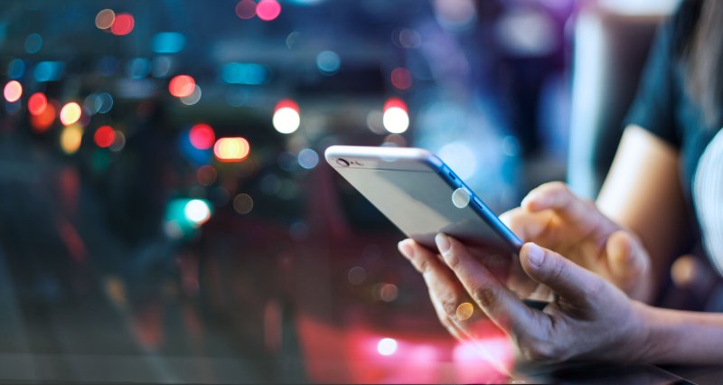 Woman using mobile smart phone in the night