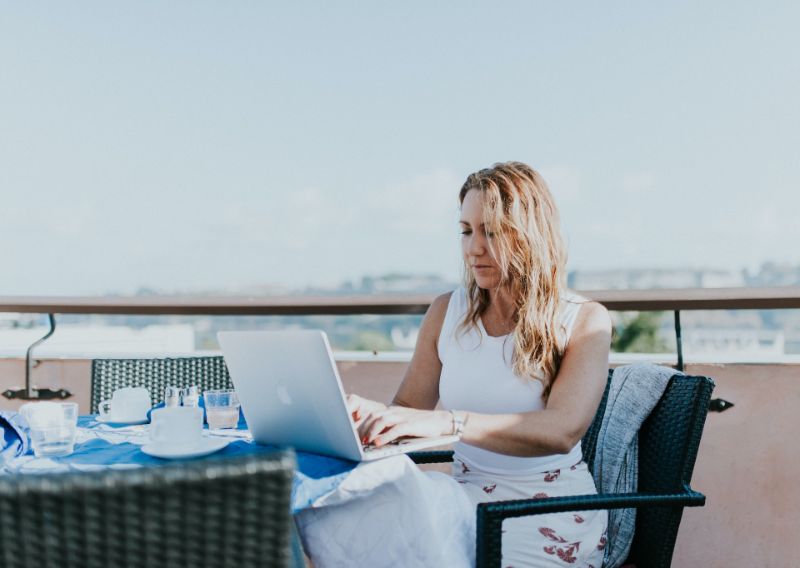 Woman using laptop outside