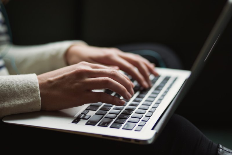 A person typing on the laptop