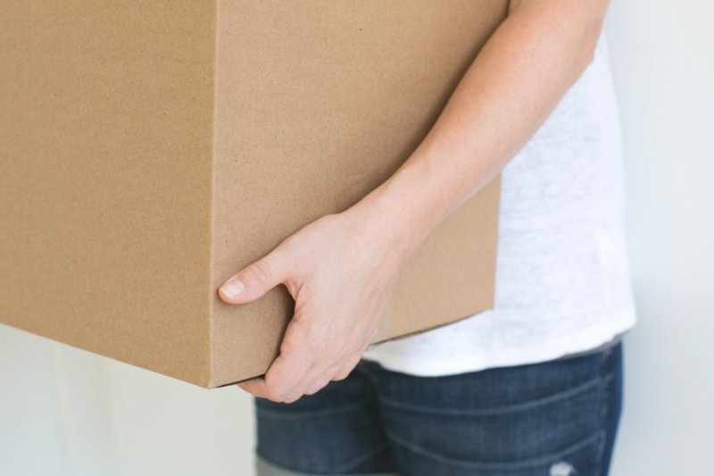 A man carrying a carton