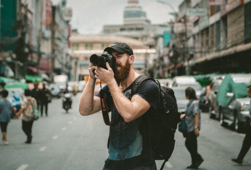 A man capturing pictures on the road