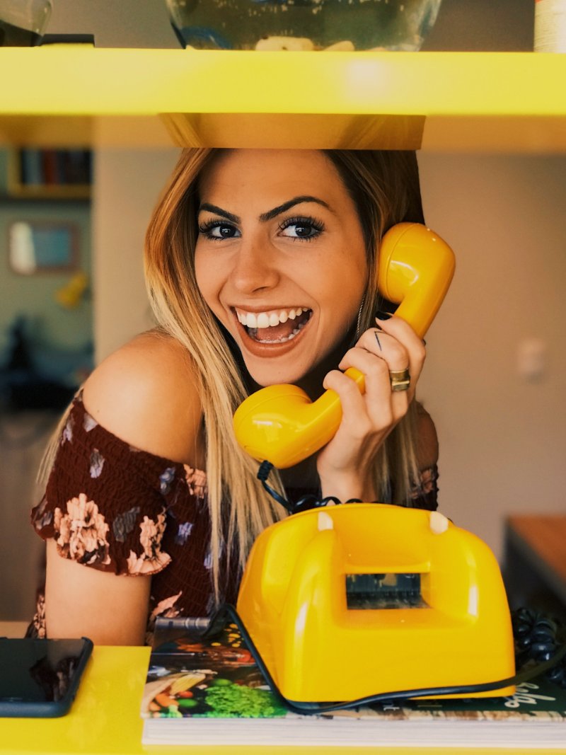 a lady talking on her telephone and smiling