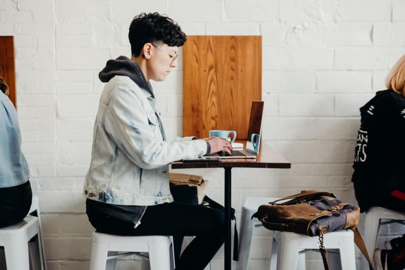 person working in a cafe on a laptop