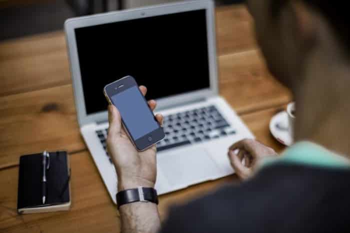 Man working on laptop and mobile