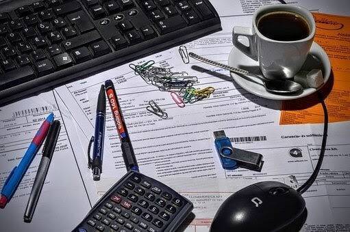 desk with office supplies and coffee