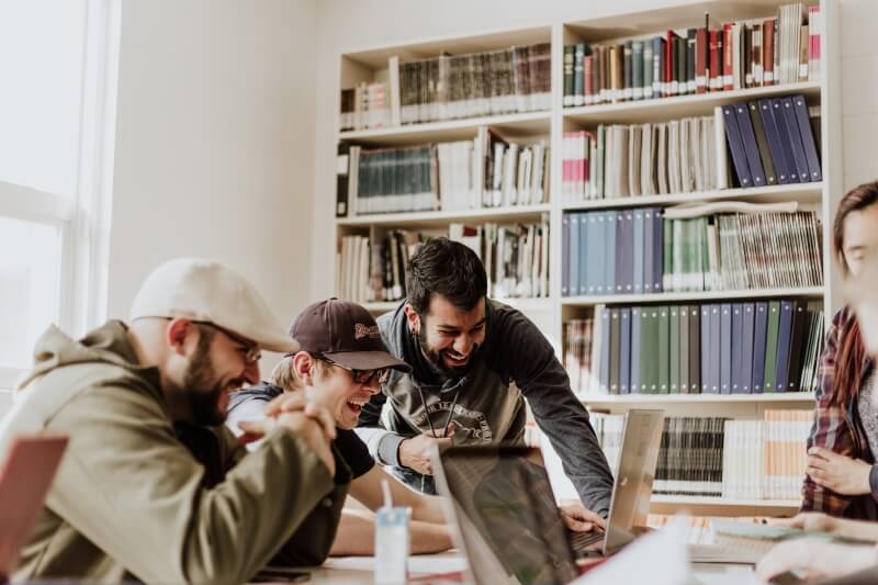 Group of Men Looking on a Laptop