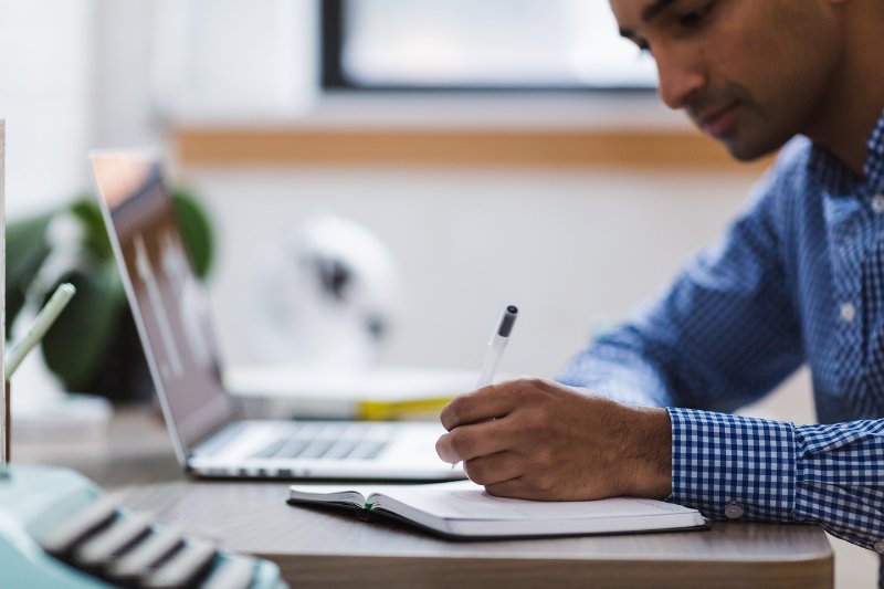 Man writing on a notebook