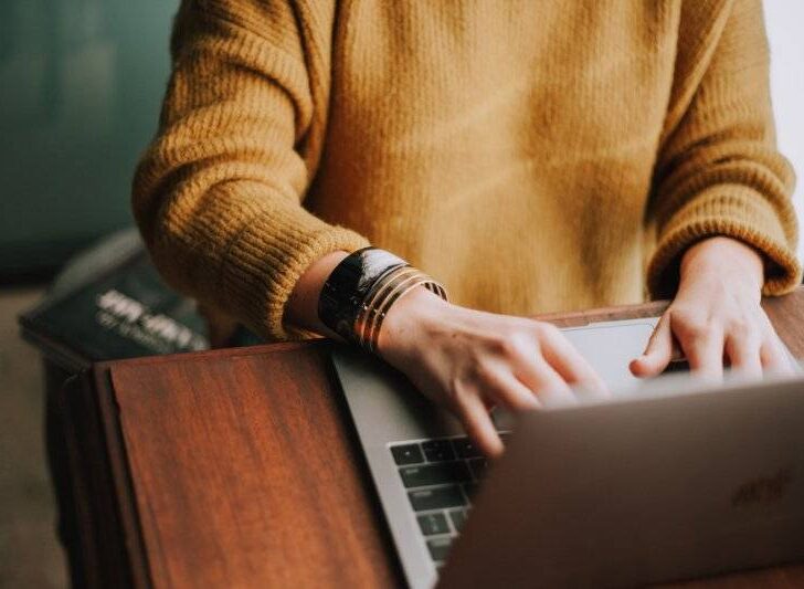 Woman Typing on a Laptop