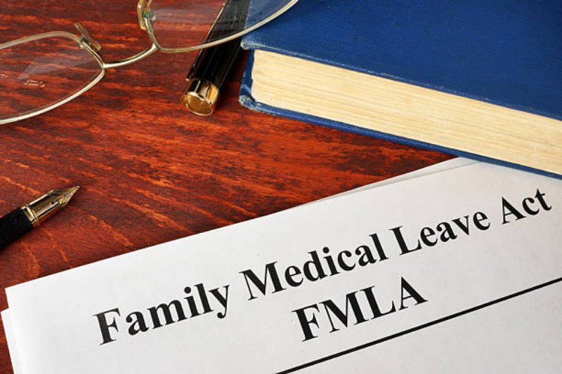 Glasses, notebook, pen, and FMLA tag on the table