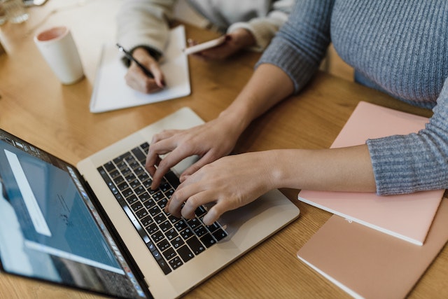 A lady typing on her laptop