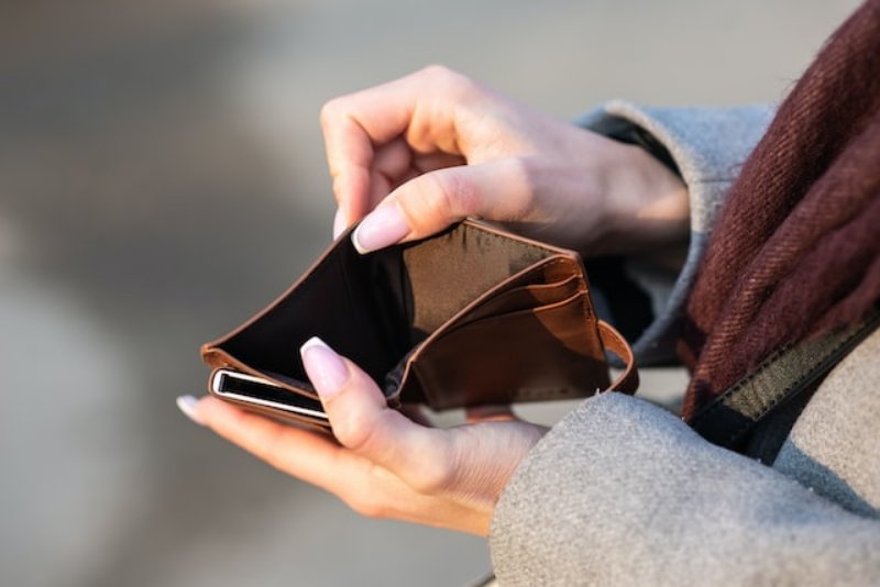 A man with an empty wallet in his hands