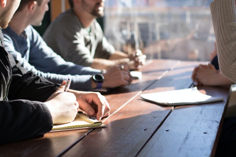 People discussing a matter around a table