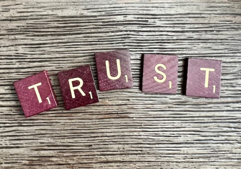 TRUST alphabets on a table