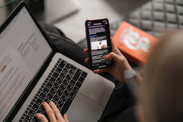 Lady using her laptop and phone