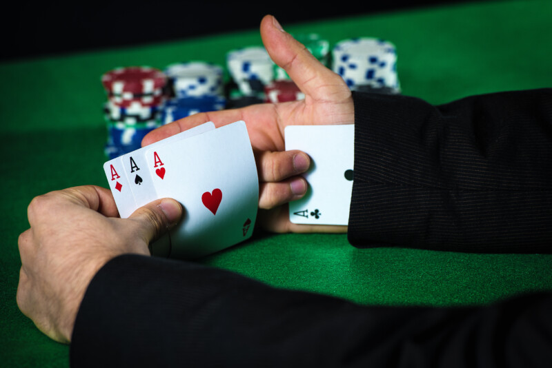 Man cheating at a poker game