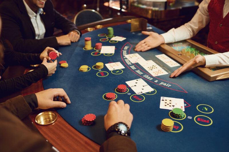 People gamble at a poker table in a casino