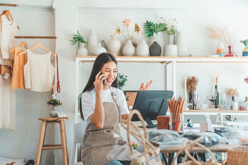 Woman Small Business Owner on the Phone with a Customer