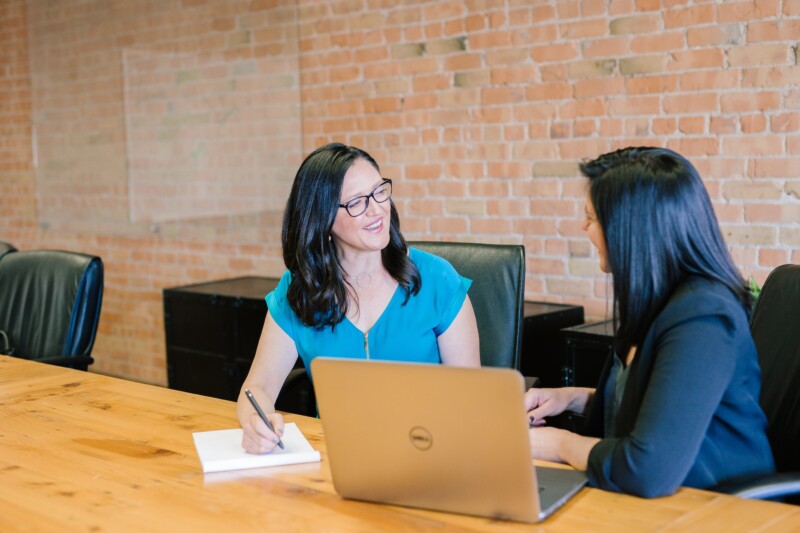 Woman talking to a woman wearing a suit jacket