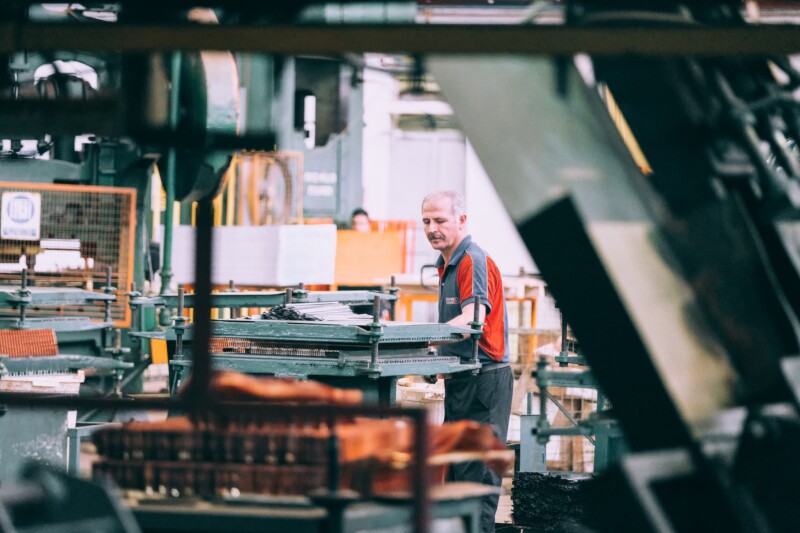 Man checking products on a clothing manufacturing facility 