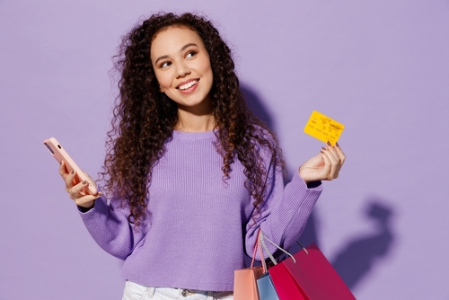 Woman with shopping bags and cards