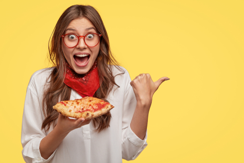 Woman happy with slice of pizza