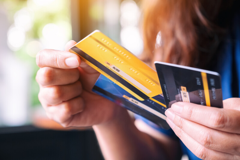 Woman holding and choosing credit card to use