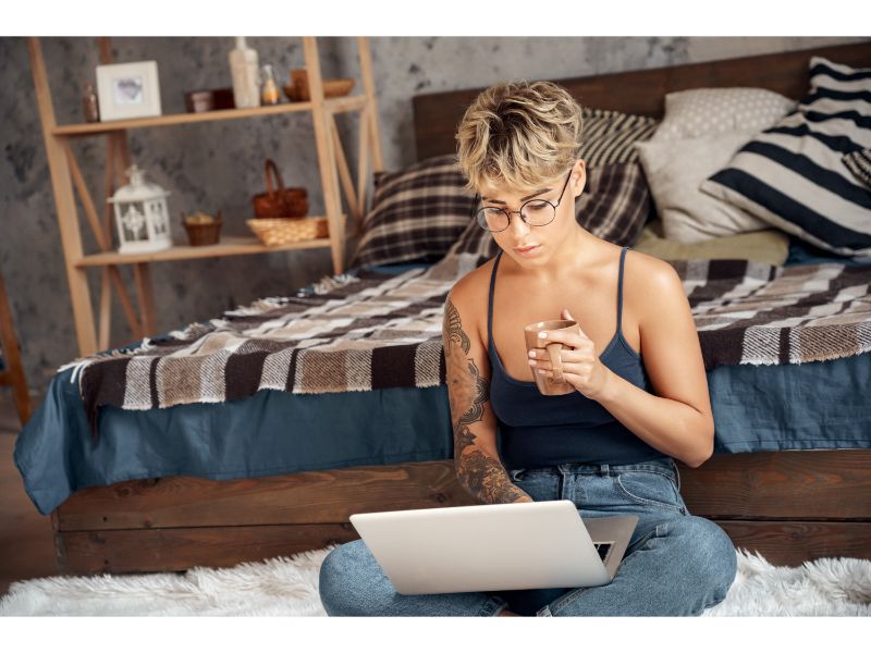 Young woman short hair in glasses with laptop