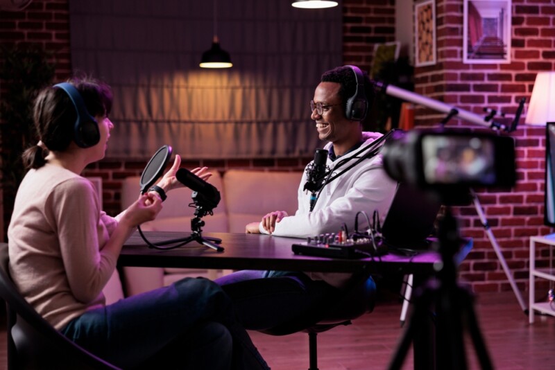 Man and woman recording podcast conversation on camera