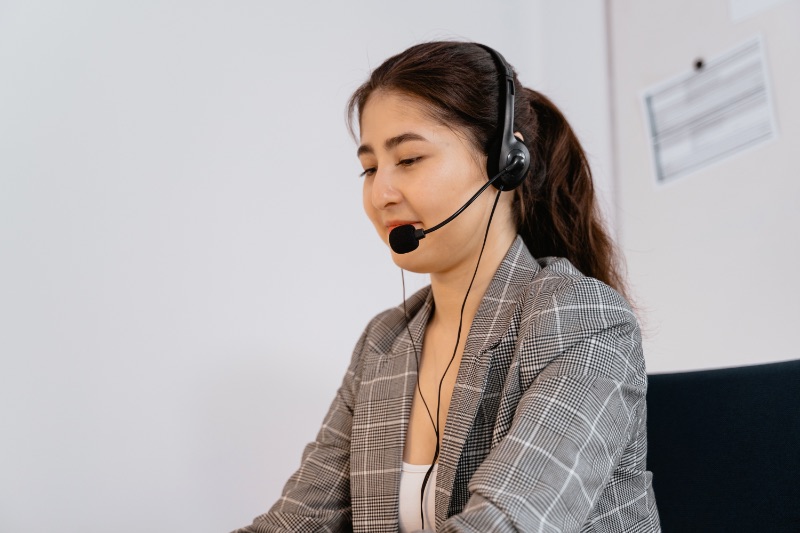 woman with a black headset on call