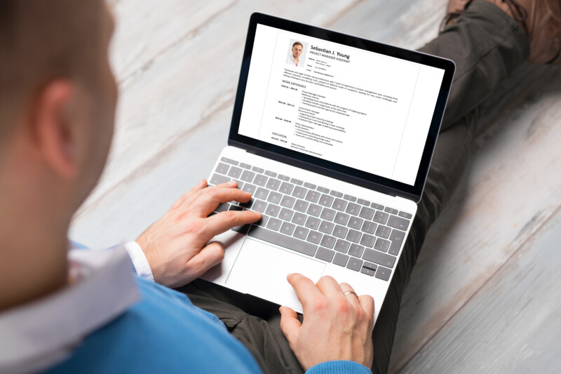 Man creating his CV on laptop