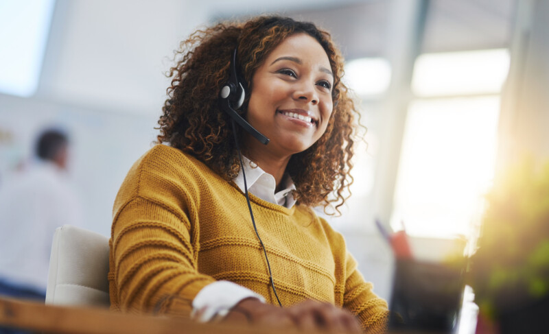 African woman, call center agent or smile with voip for consulting, listening or contact us in office