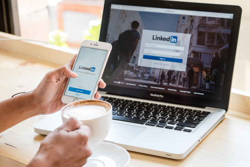 A women holds Apple iPhone 6S with LinkedIn application on the screen.LinkedIn is a photo-sharing app for smartphones.