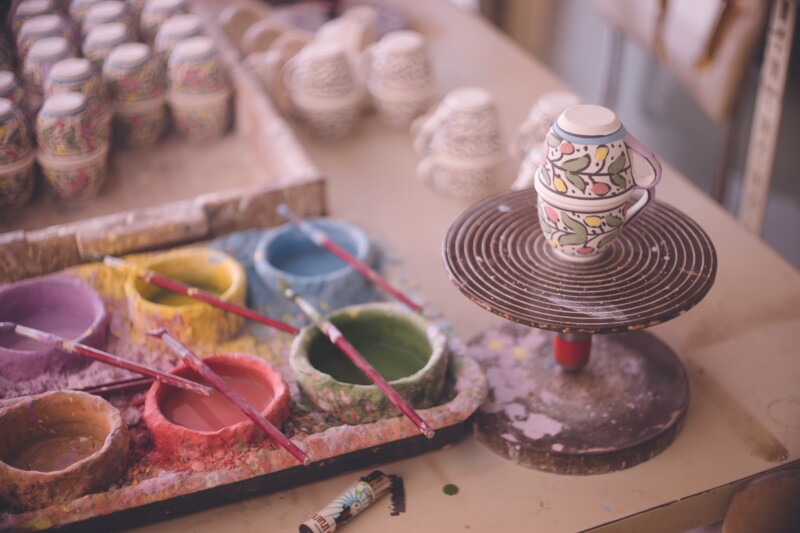 Traditional artisans painting souvenir pottery in Bethlehem, Palestine and the Middle East, Israel.
