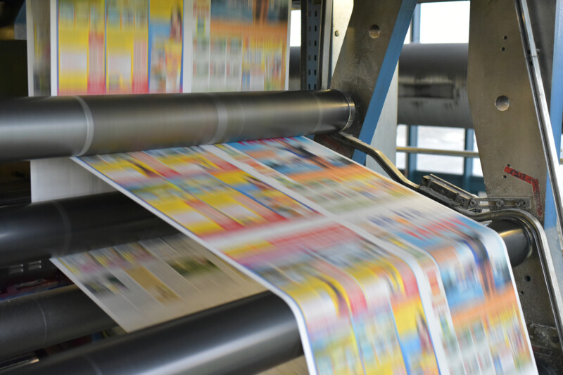 Paper rolls and offset printing machines in a large print shop for production of newspapers and magazines