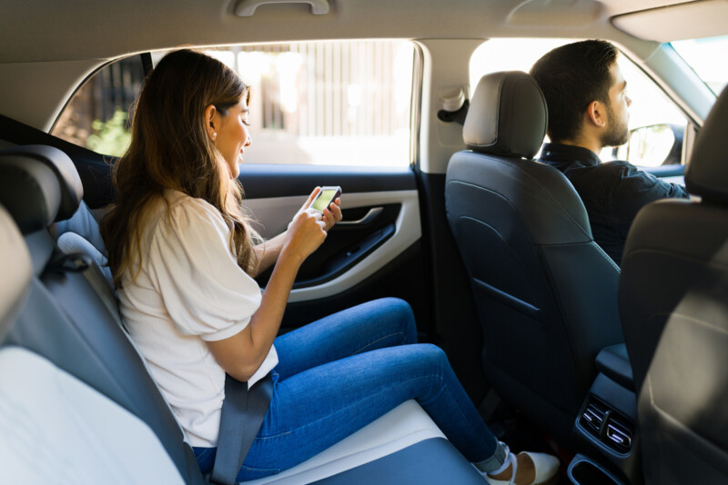 Female passenger texting in the car