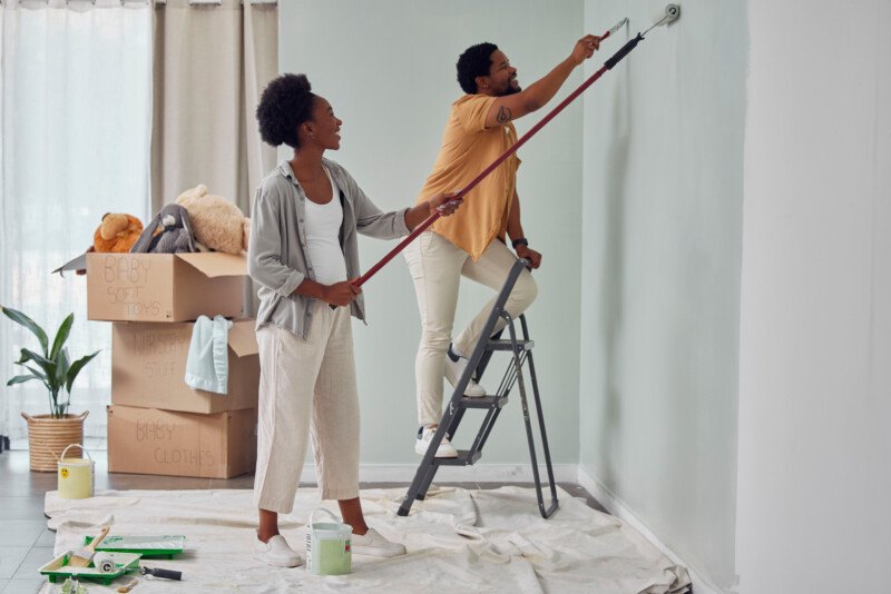 Happy smile, woman and African man love working on wall with partnership or collaboration