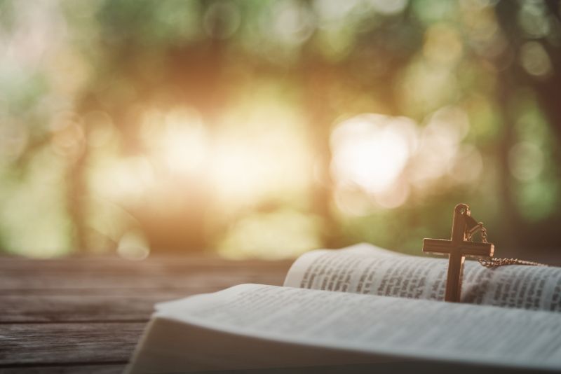 Holy bible with wooden cross on a table