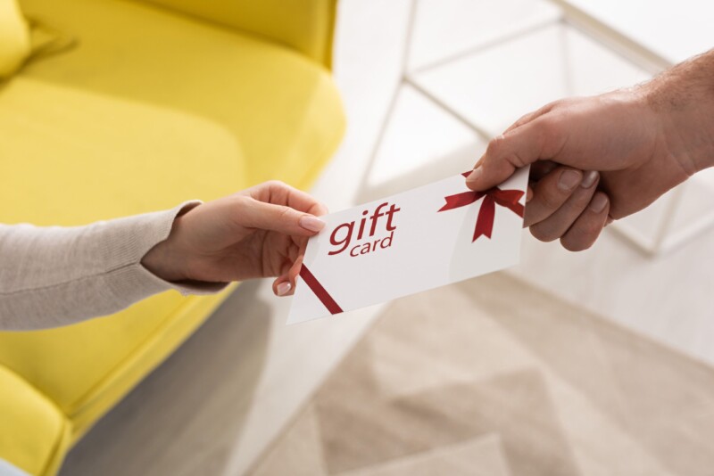 Cropped view of man giving gift card