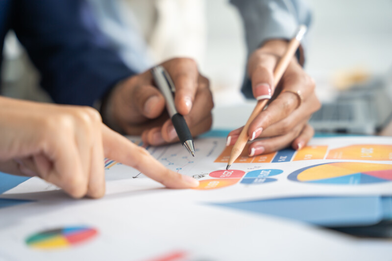 Group of people analyzing a graph