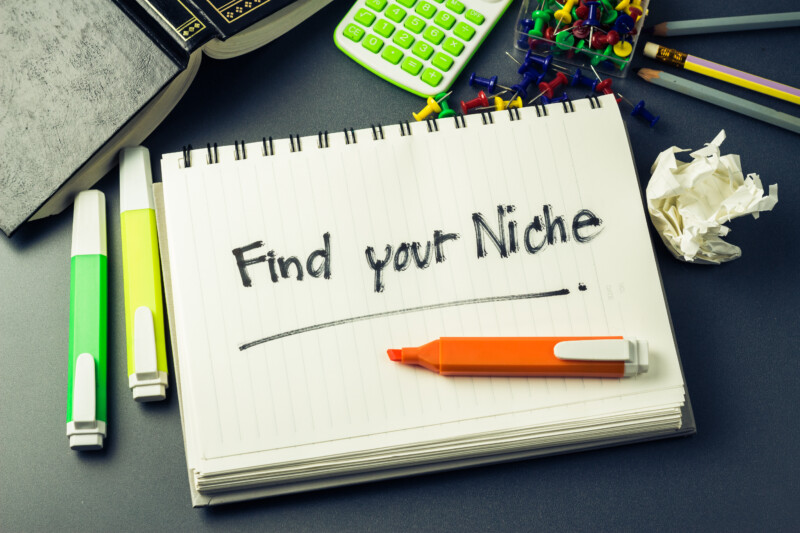 Written Find Your Niche on a Notebook