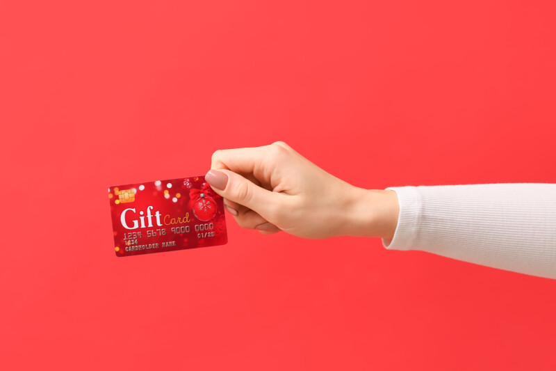 Woman holding a red gift card